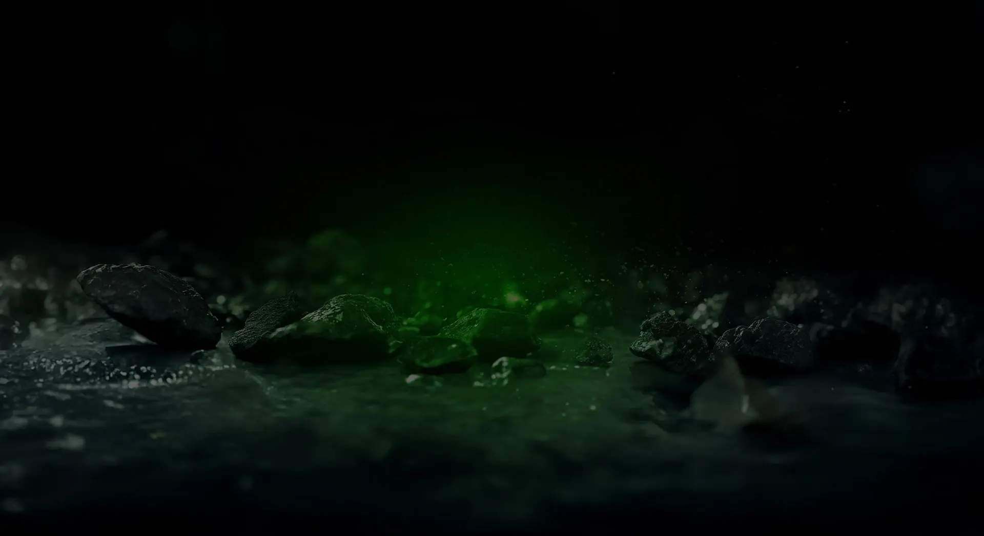 Rocas oscuras junto al agua con una bruma verde
